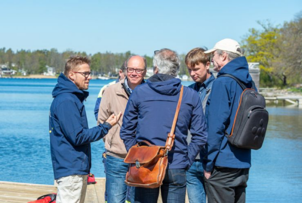 Five men having an discussion in a group.